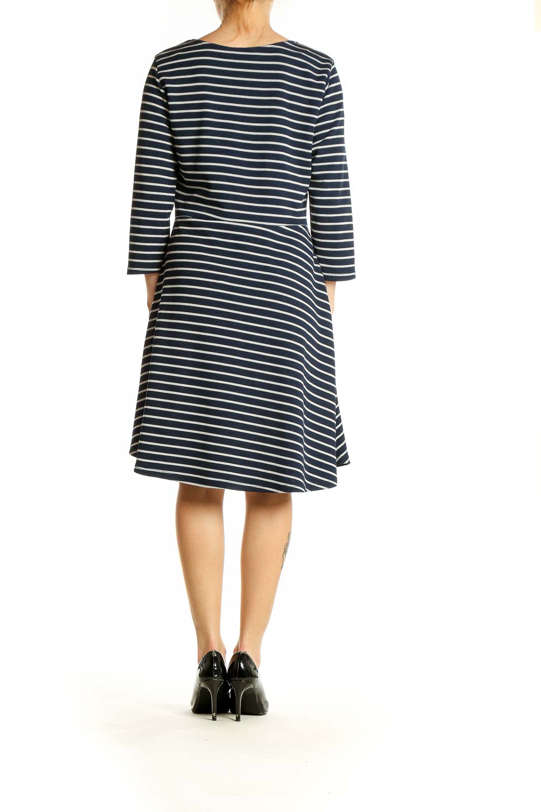 Side view of Gilli navy and white striped A-line dress showing flattering silhouette