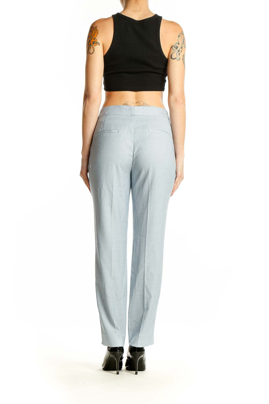 Side view of Zara light blue straight-leg trousers on model with black top