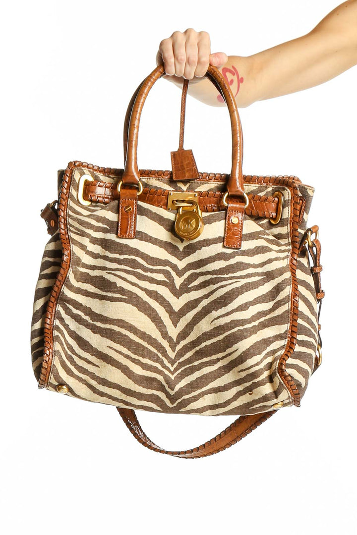 Front view of Michael Kors brown zebra print leather tote bag with cognac trim