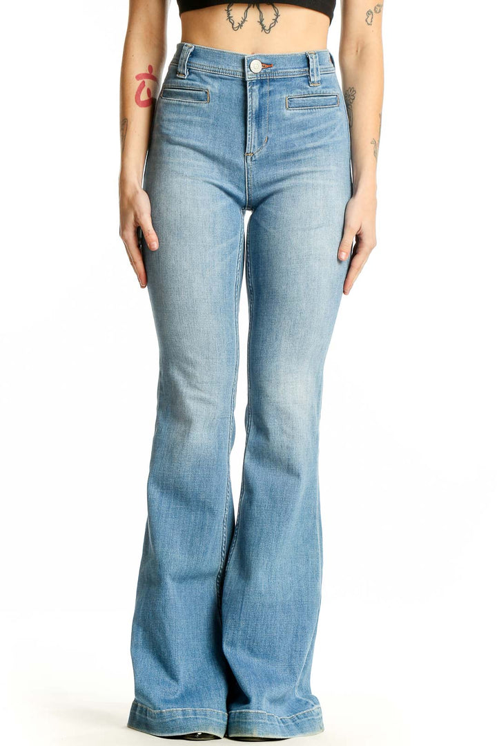 Front view of Ditto's light blue high-waisted flared jeans on model