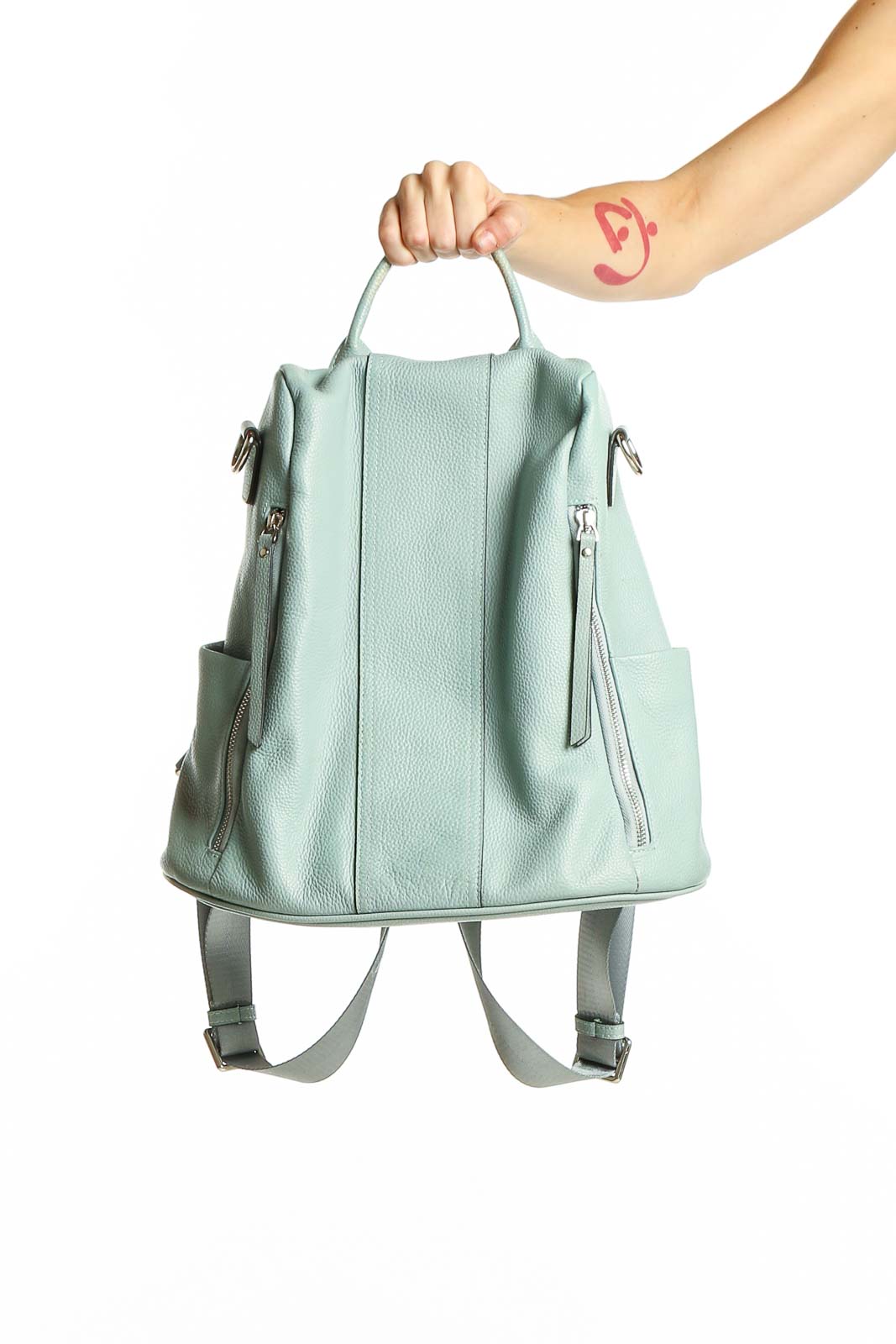 Front view of S-ZONE mint green leather convertible backpack held by model