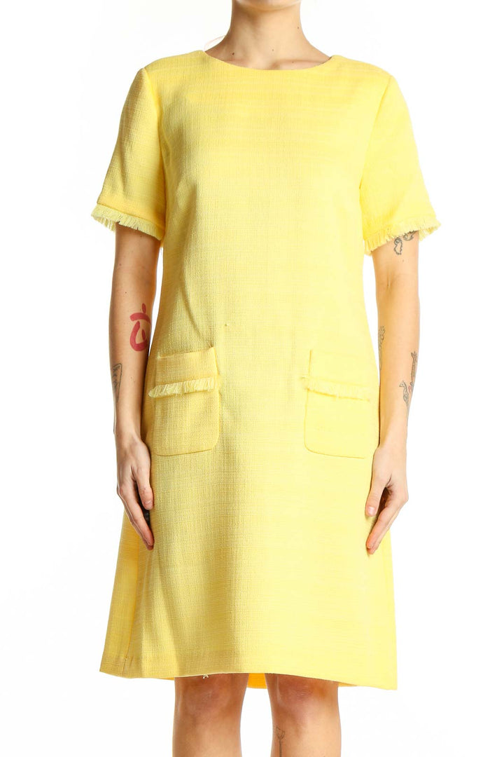 Front view of Tommy Hilfiger yellow textured shift dress with frayed edges and front pockets