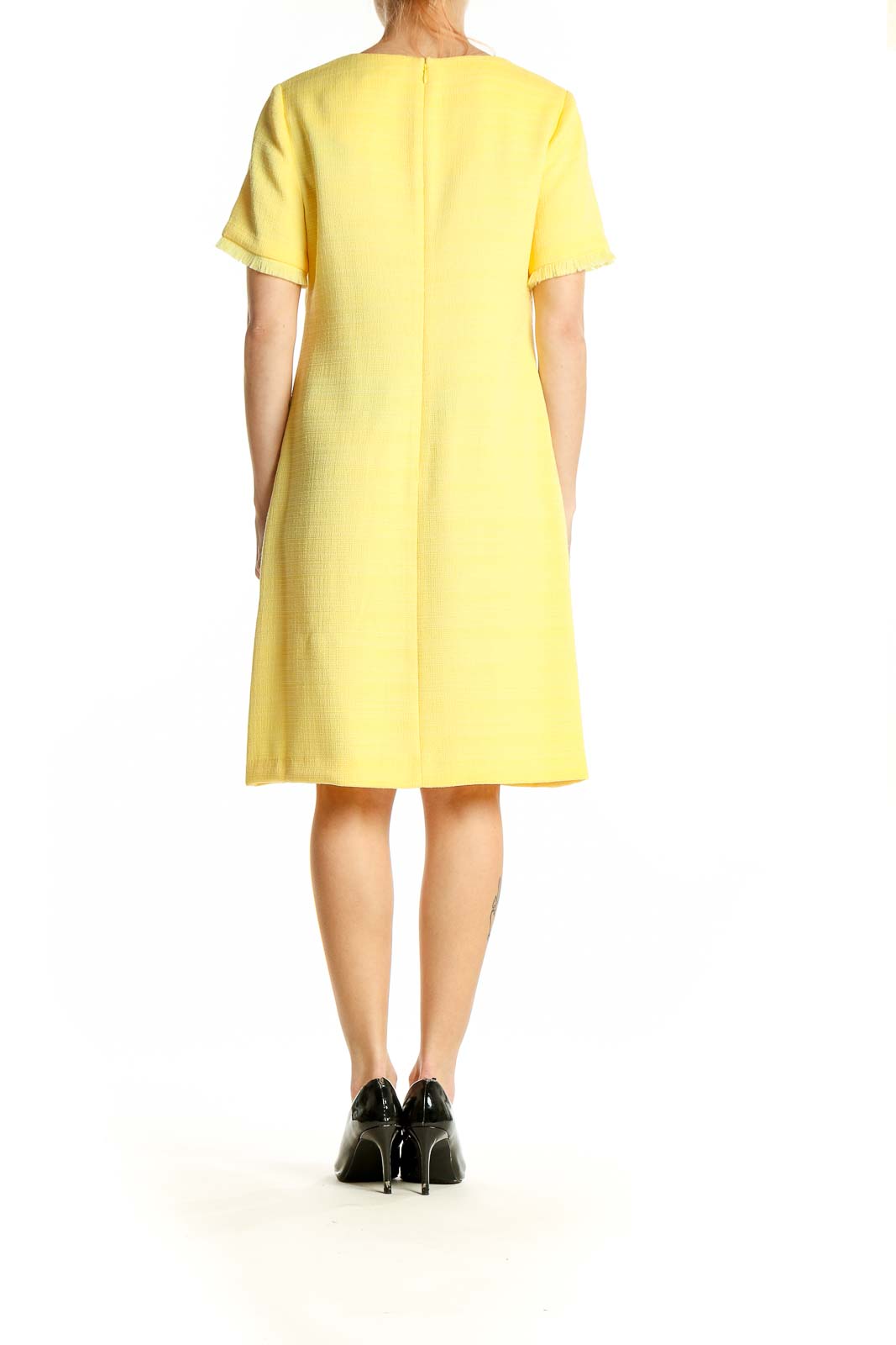 Side view of Tommy Hilfiger yellow textured shift dress showing silhouette and length