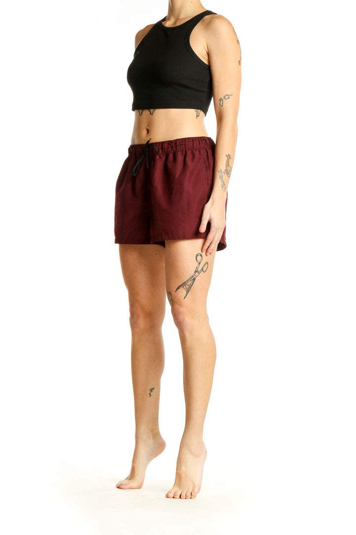 Front view of burgundy ASOS athletic shorts with elastic waistband