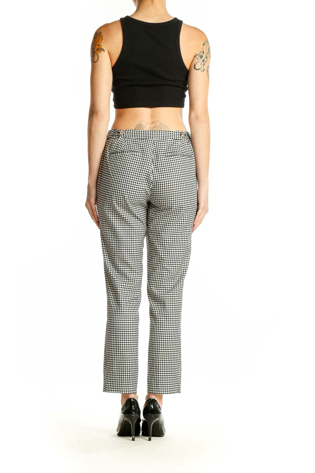 Side view of model wearing Calvin Klein black and white gingham check ankle pants