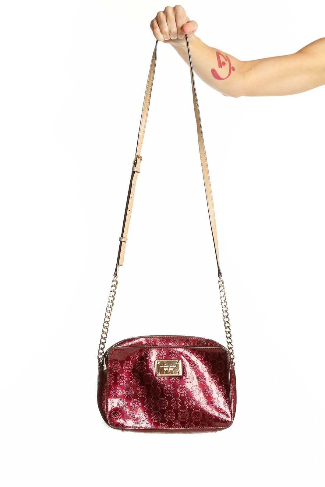 Front view of Michael Kors burgundy monogram crossbody bag with gold chain strap