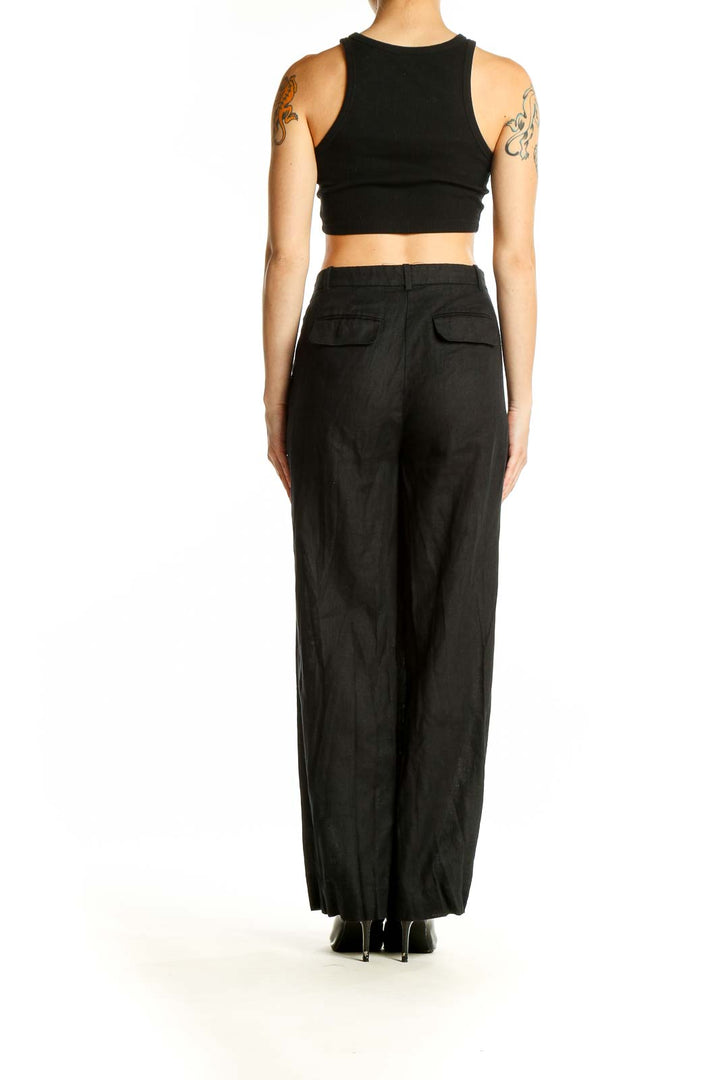 Back view of J.Crew black linen wide-leg trousers on model with crop top