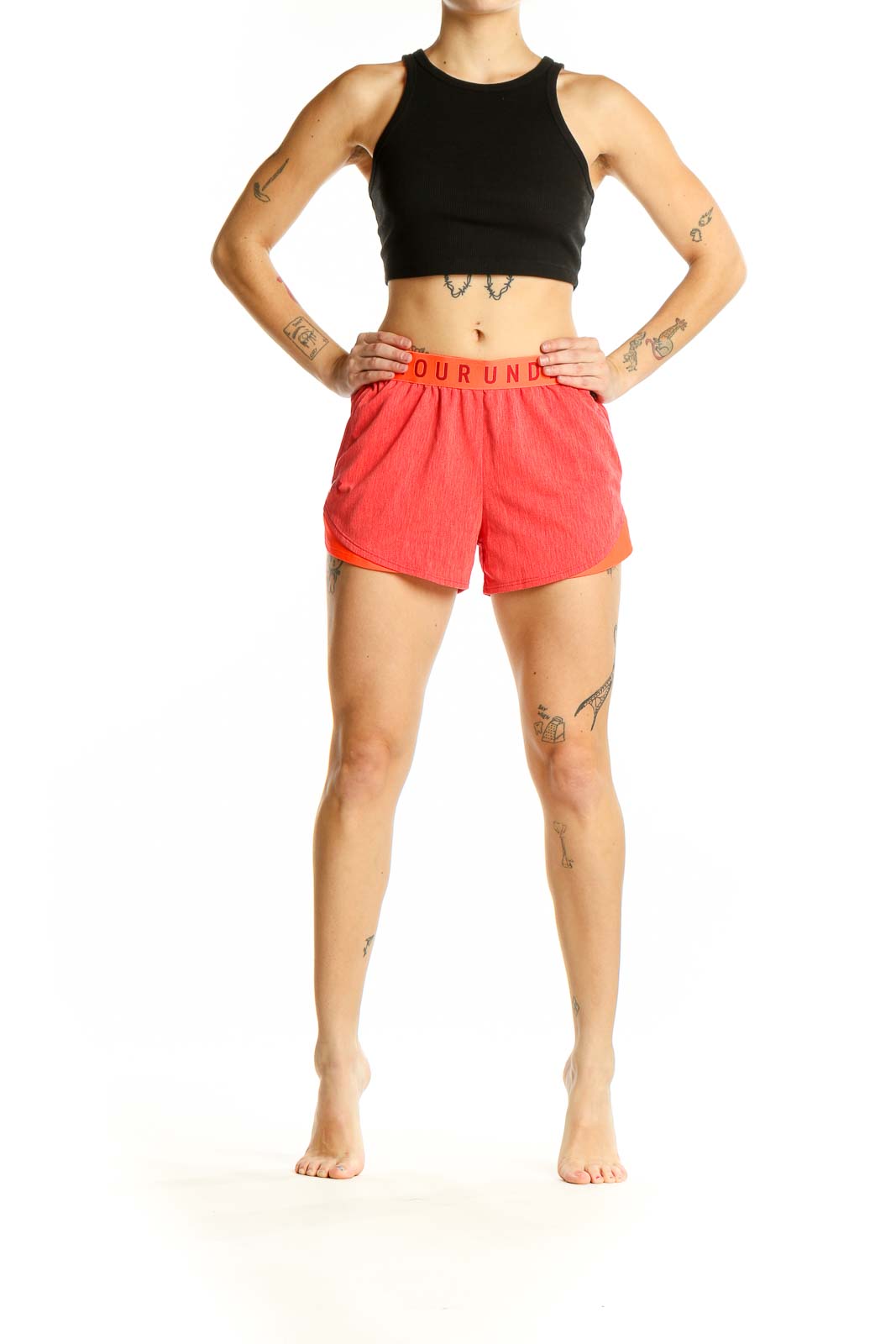 Front view of coral Under Armour athletic shorts with branded waistband