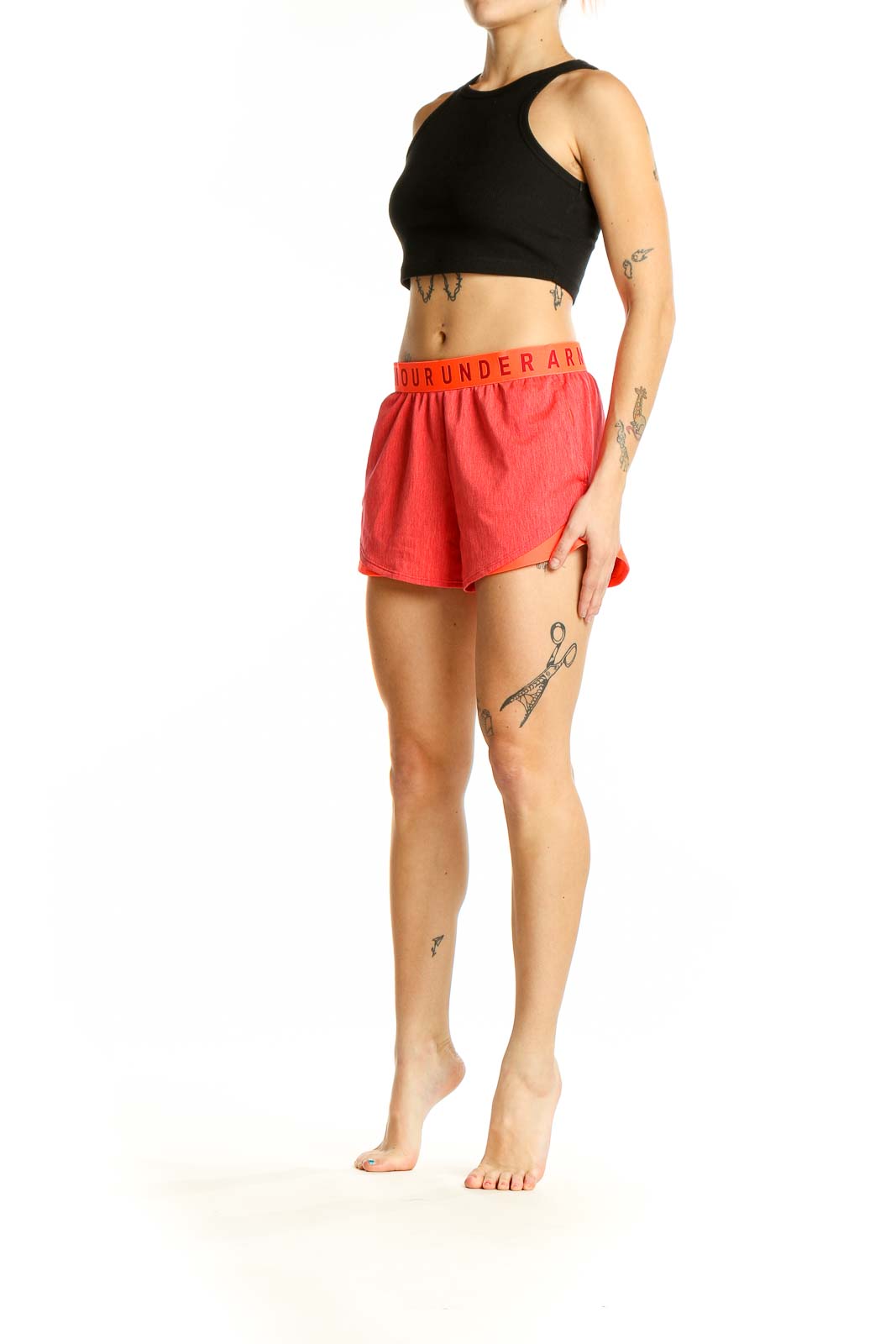 Front view of coral Under Armour athletic shorts with branded waistband