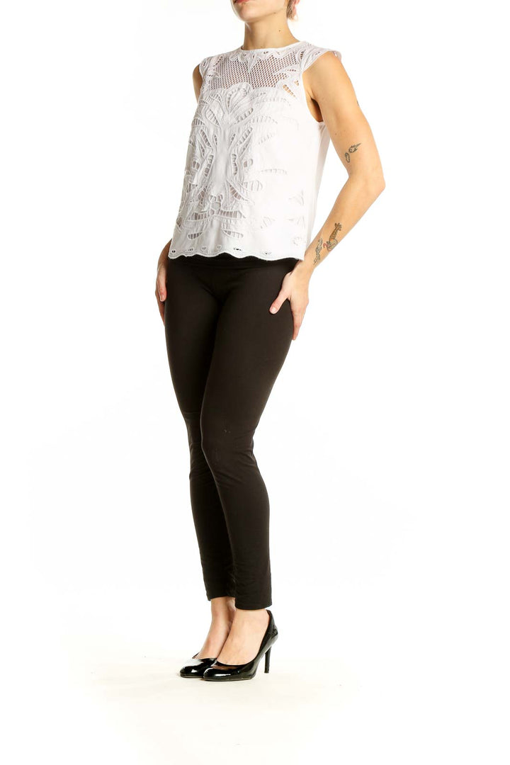 Front view of White House Black Market white lace sleeveless blouse with floral pattern