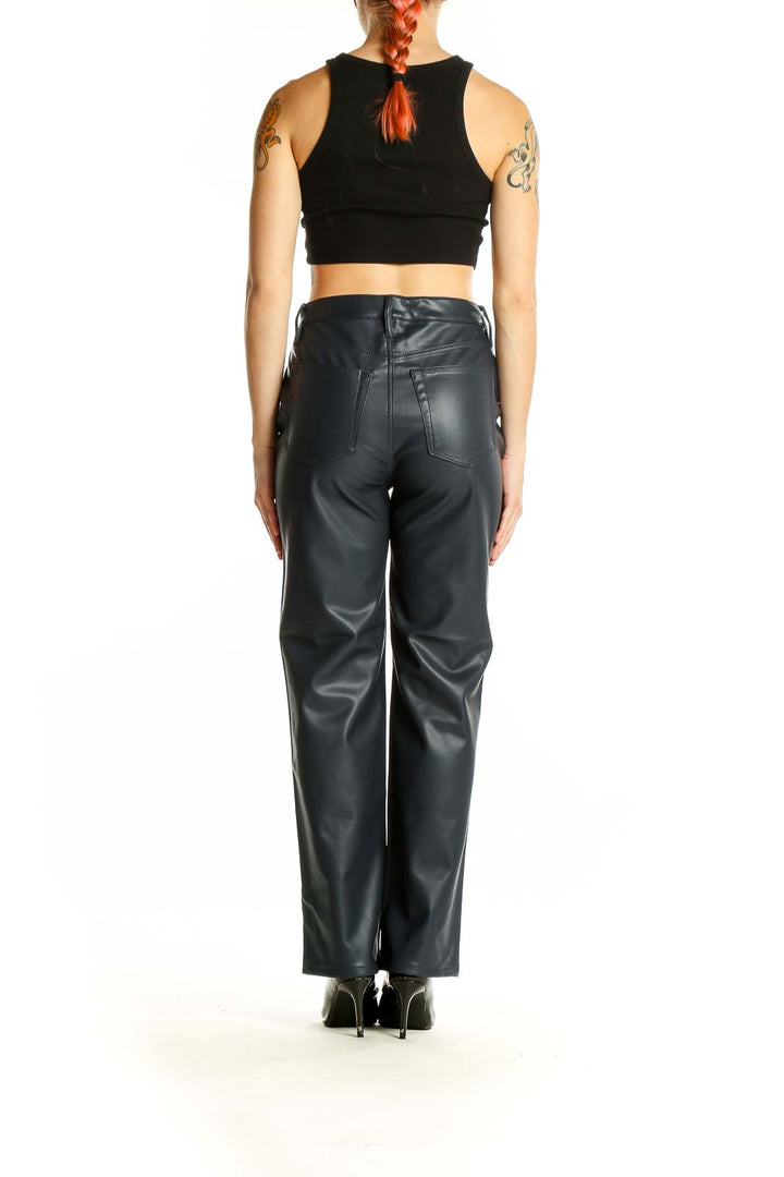 Side view of LOFT black faux leather wide-leg pants on model with crop top