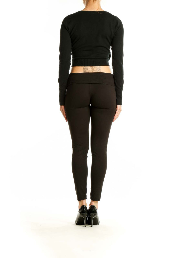 Back view of black wrap-style cropped sweater by Dreamers by debut