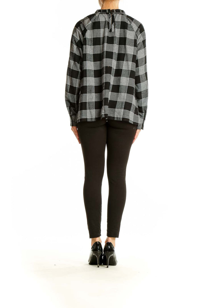 Back view of LOFT black and white plaid long sleeve blouse on model