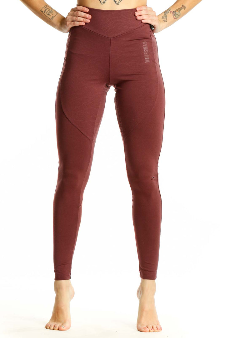 Front view of burgundy Gymshark high-waisted leggings on model