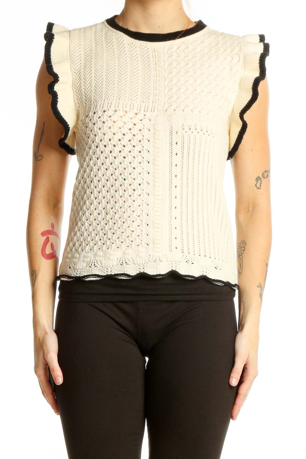 Front view of cream sleeveless knit top with ruffled armholes and mixed knit patterns