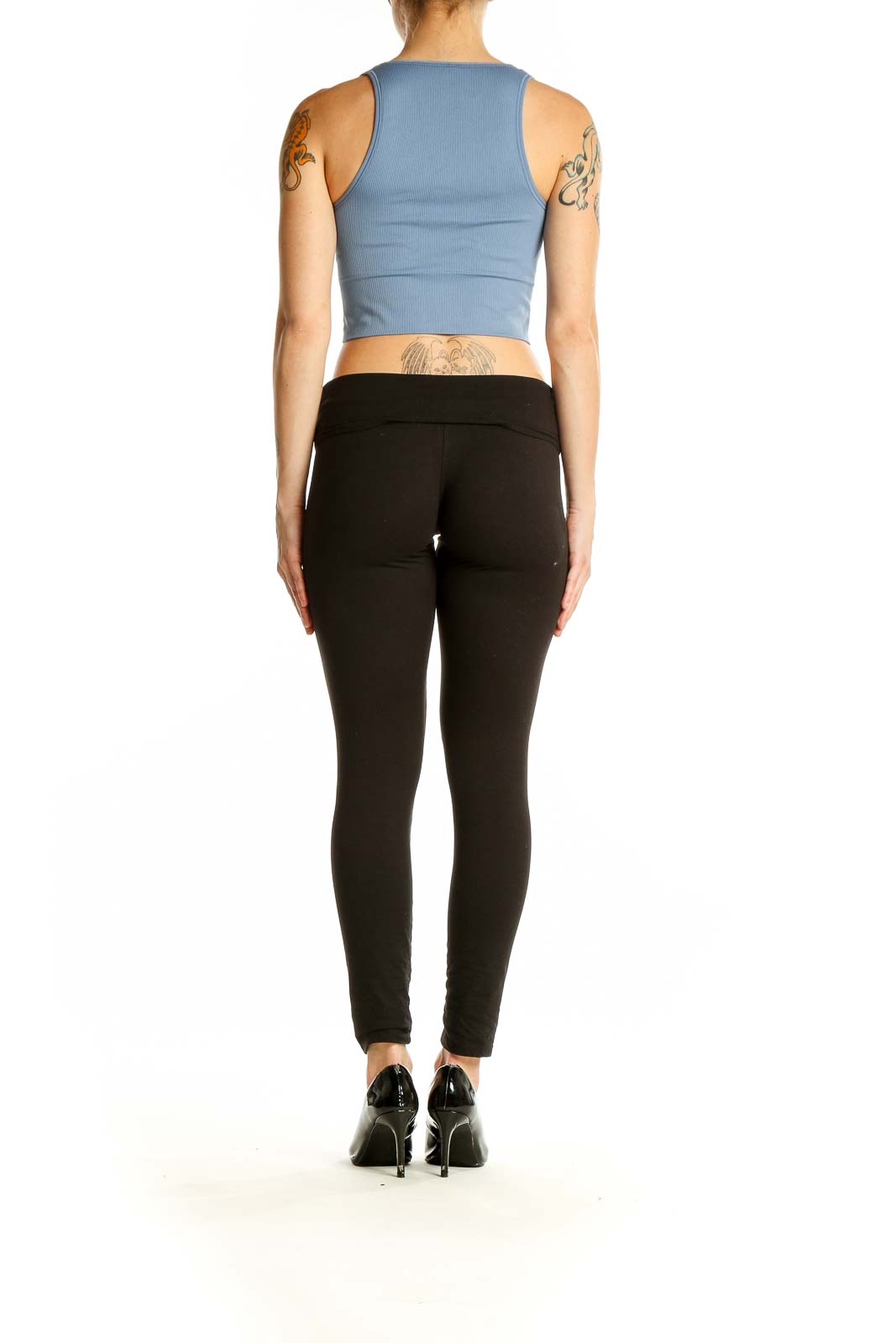 Side view of blue ribbed crop tank top from Athleta with black leggings