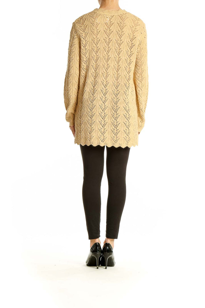 Back view of beige acrylic lurex sweater showing full length and fit