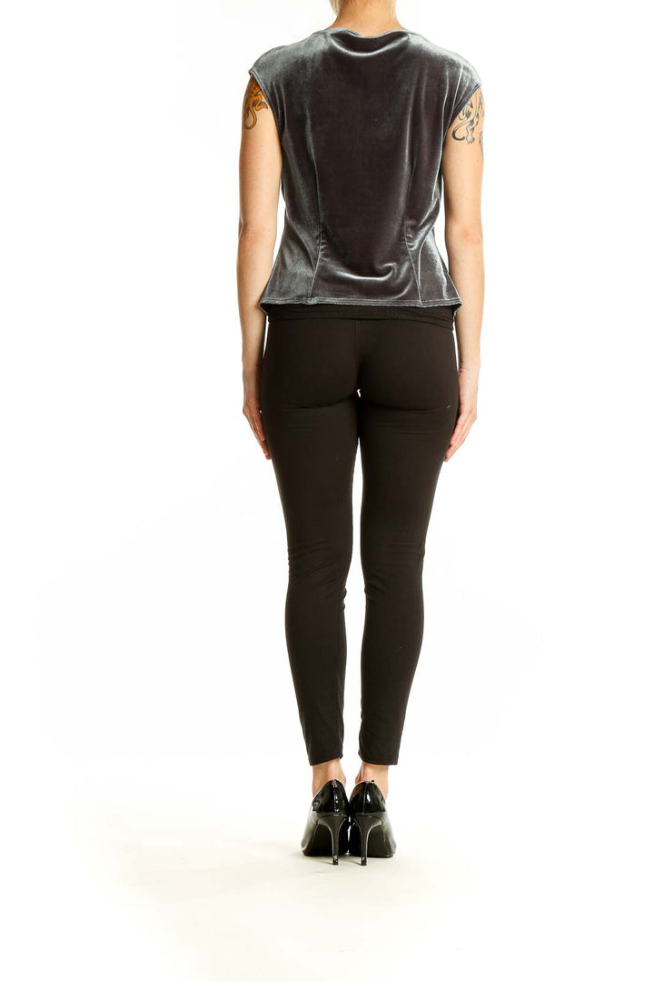 Side view of gray velvet sleeveless top by Laundry on model with black pants