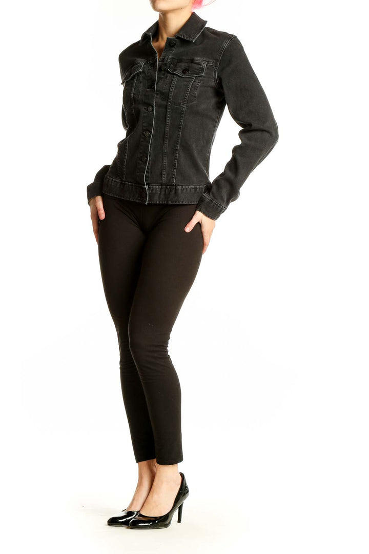 Front view of Calvin Klein black denim jacket on model