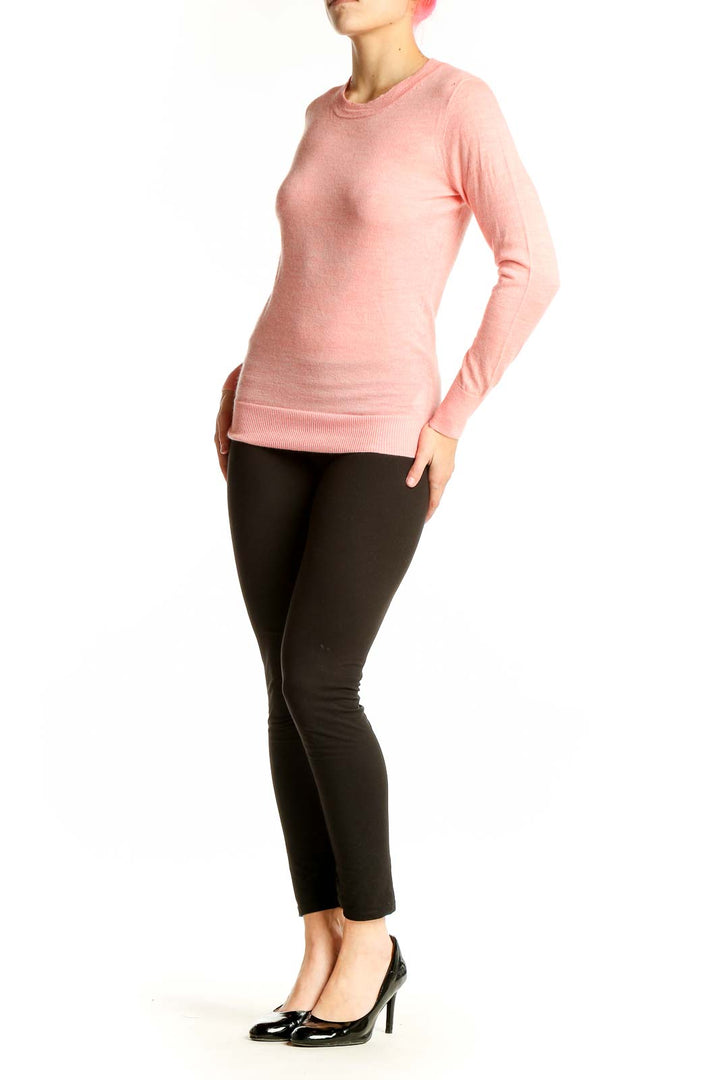 Front view of J.Crew pink cashmere crewneck sweater on model