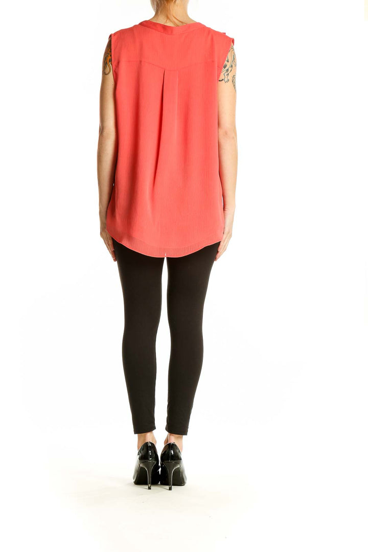 Back view of coral Tommy Hilfiger sleeveless blouse showing high-low hem