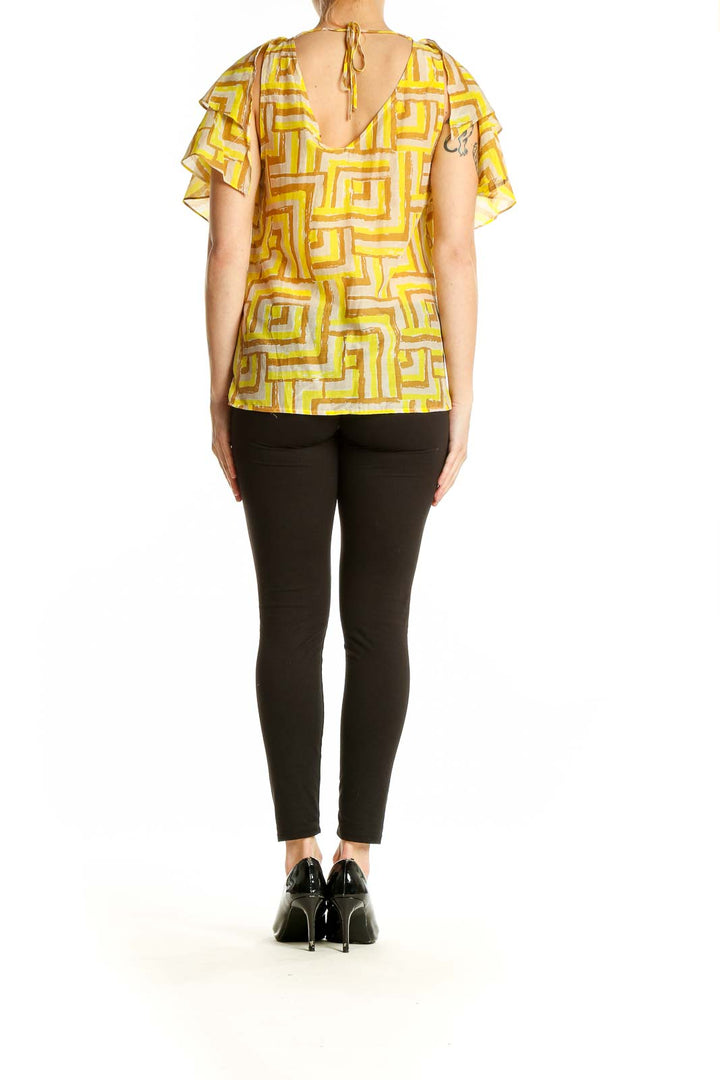 Side view of Sugarlips Yellow Geometric Print Ruffled Blouse showing fluttery sleeves