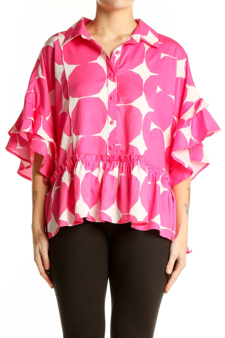 Front view of pink and white polka dot blouse with ruffled sleeves