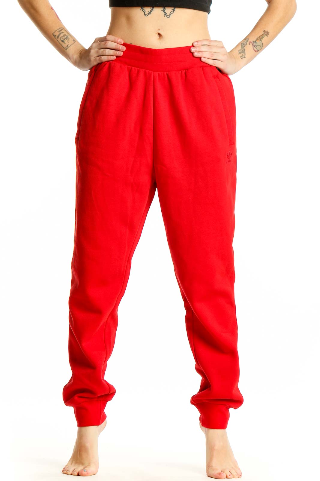 Front view of red Adidas cotton jogger sweatpants with elastic waistband