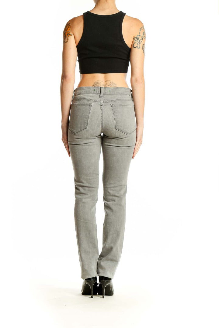 Side view of woman wearing J Brand gray slim fit stretch denim jeans