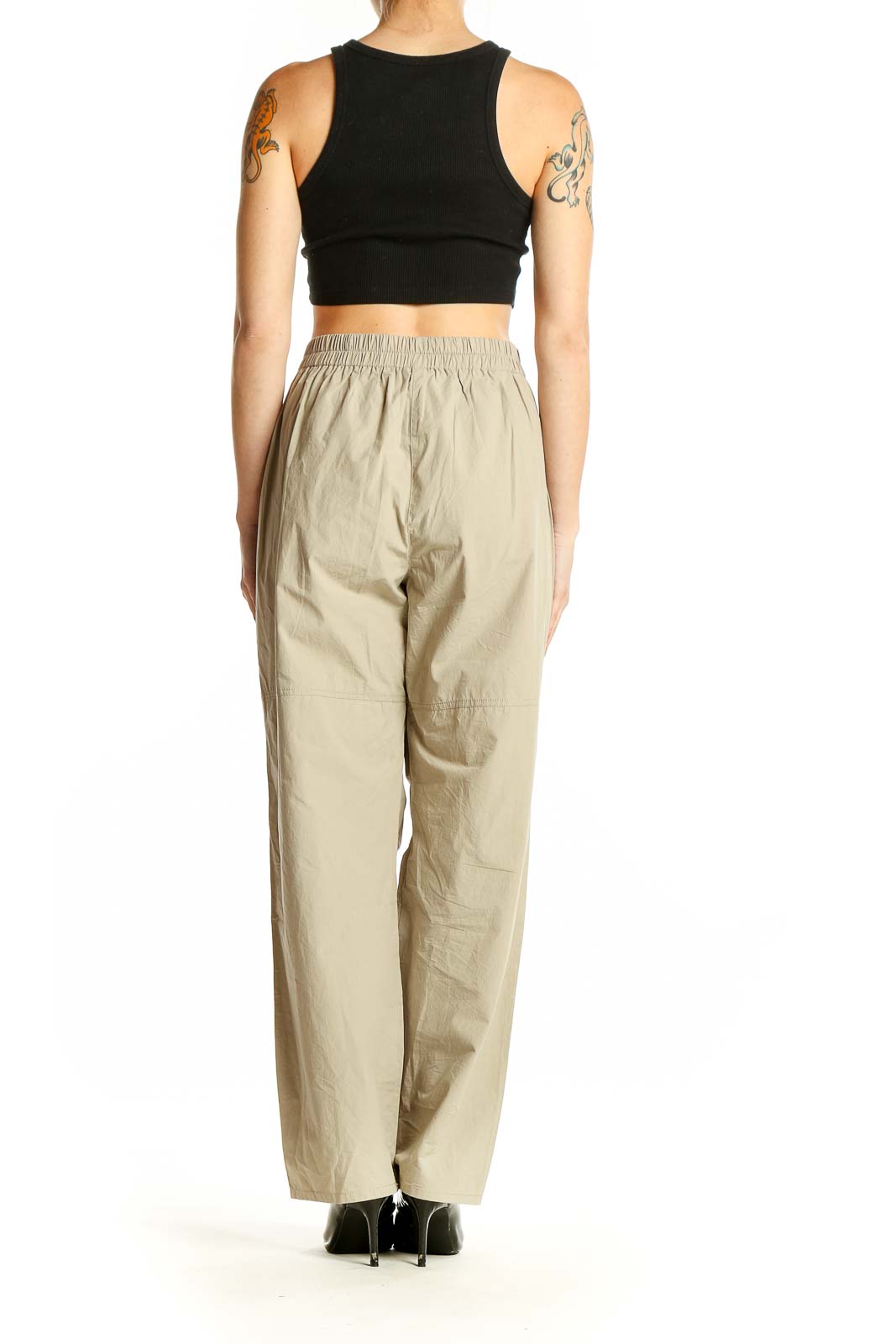 Side view of model wearing Ruti beige cotton high-waisted wide-leg pants with black top