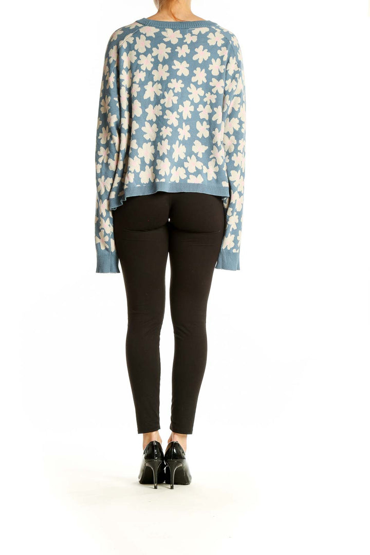 Back view of Spiritual Gangster blue floral knit sweater showing oversized fit and pattern continuity