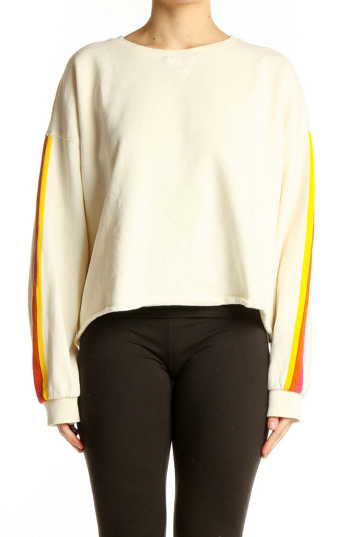 Front view of Marine Layer cream cropped sweatshirt with rainbow stripes on sleeves