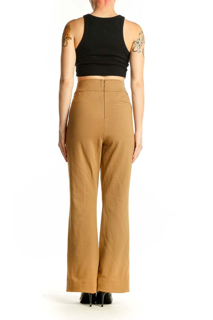 Side view of model wearing J.Crew camel high-waisted wide-leg trousers with black top