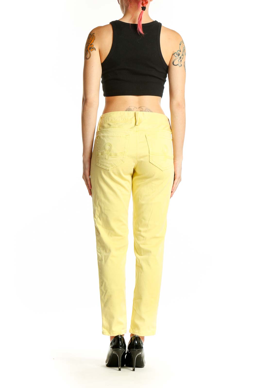 Side view of woman wearing Lilly Pulitzer yellow straight leg jeans with black top