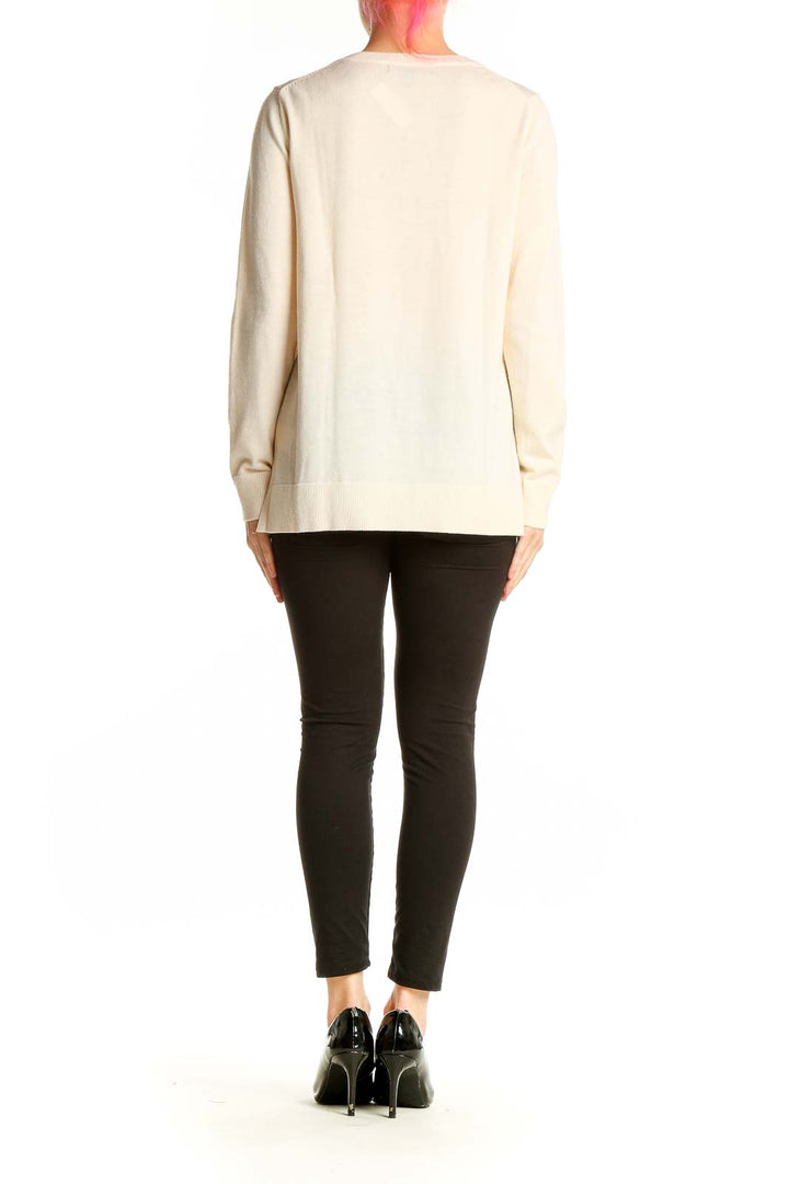 Side view of cream Merino wool crewneck sweater from Banana Republic on model