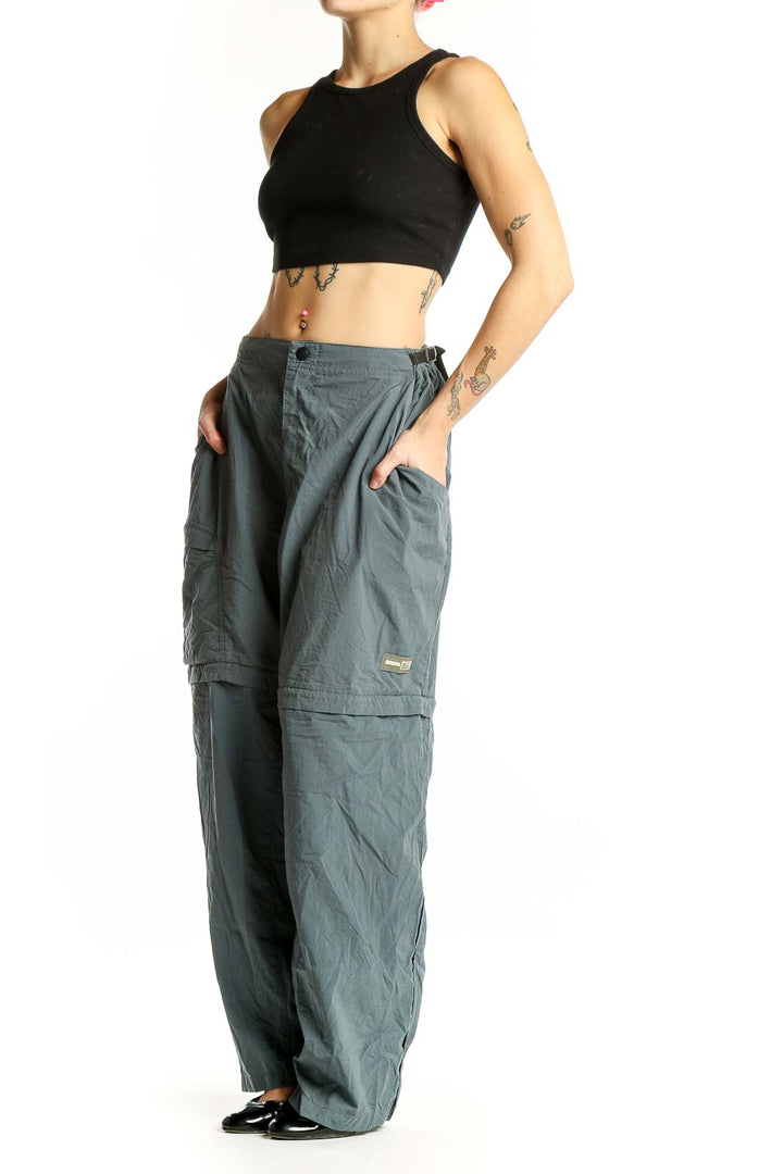 Front view of sage green REI convertible cargo pants