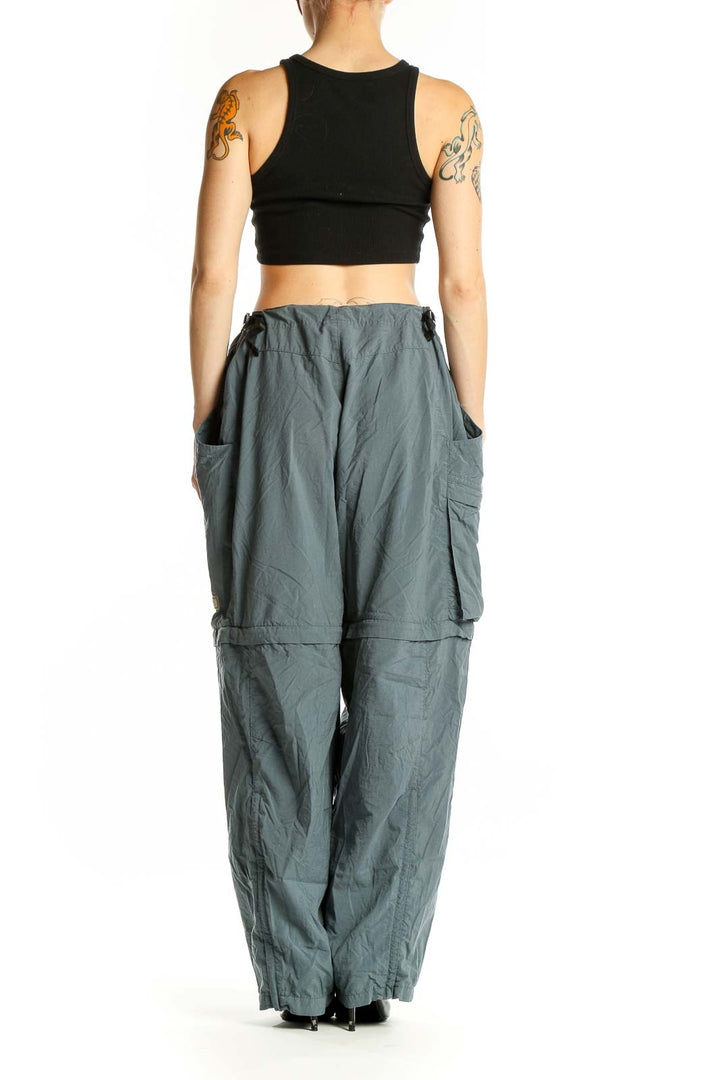 Side view of model wearing sage green REI convertible cargo pants