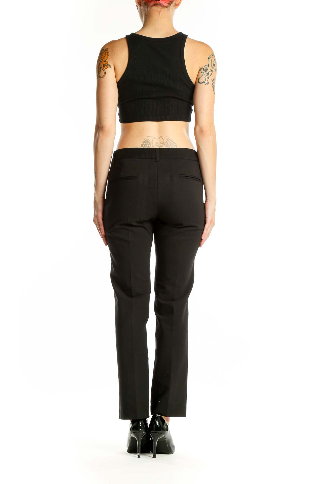 Side view of woman wearing AMANDA + CHELSEA black straight-leg trousers with black top