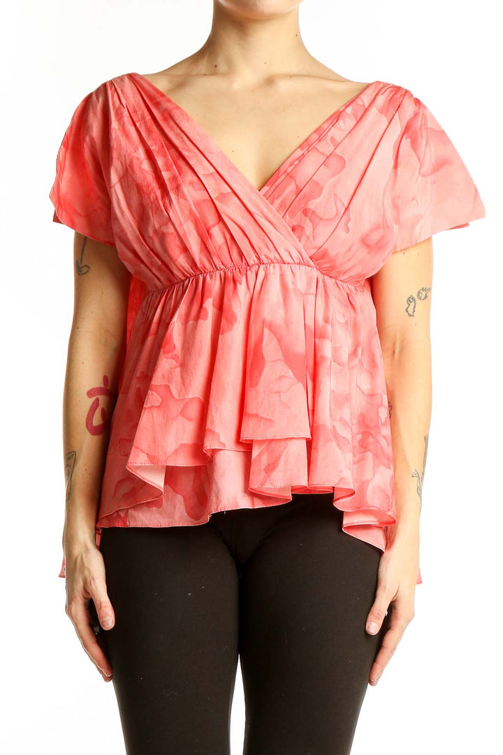 Front view of THAKOON coral floral peplum blouse with V-neck wrap