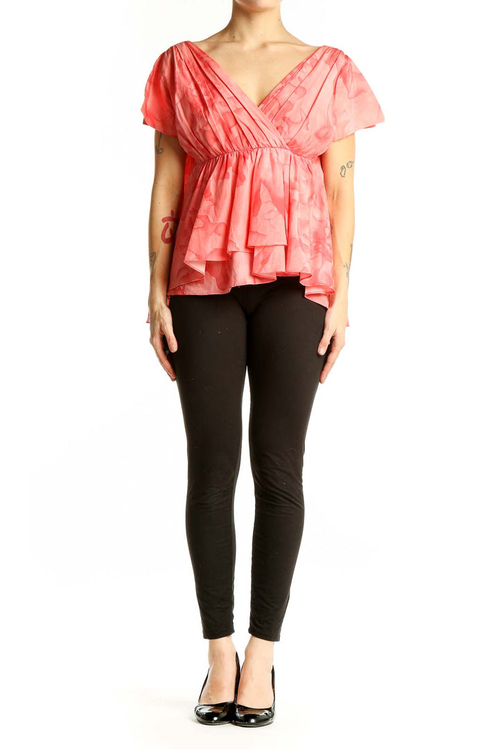 Front view of THAKOON coral floral peplum blouse with V-neck wrap