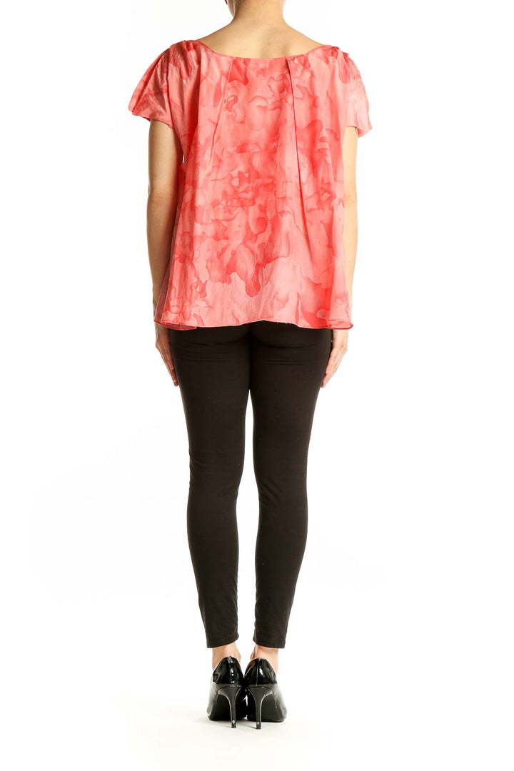 Back view of THAKOON coral floral peplum blouse showing flared silhouette