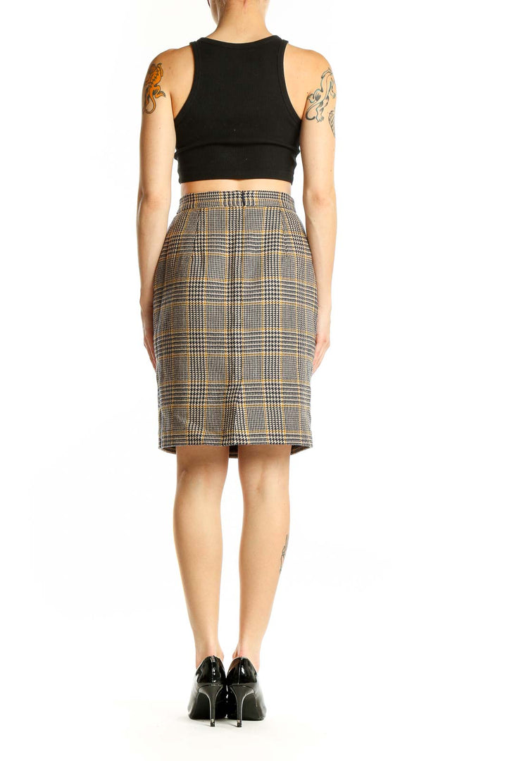 Side view of model wearing Banana Republic brown plaid wool pencil skirt with black top