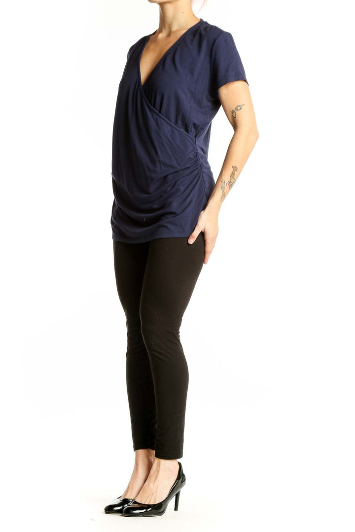 Front view of navy Boden wrap-style short sleeve top