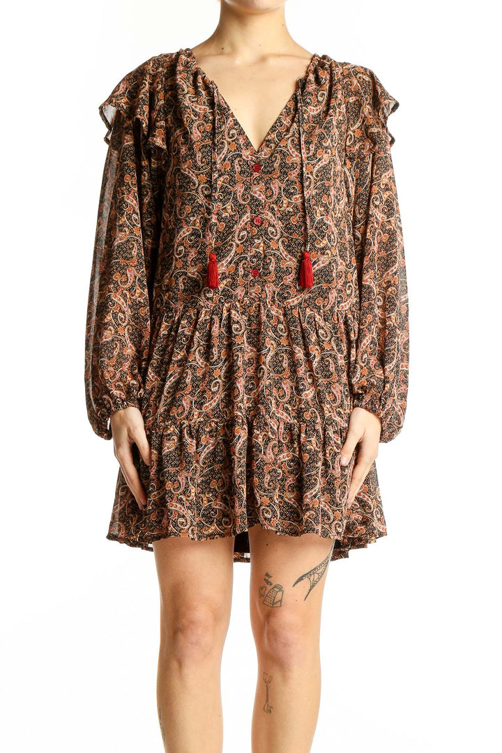 Front view of Aakaa brown paisley boho mini dress with V-neck and red tassels