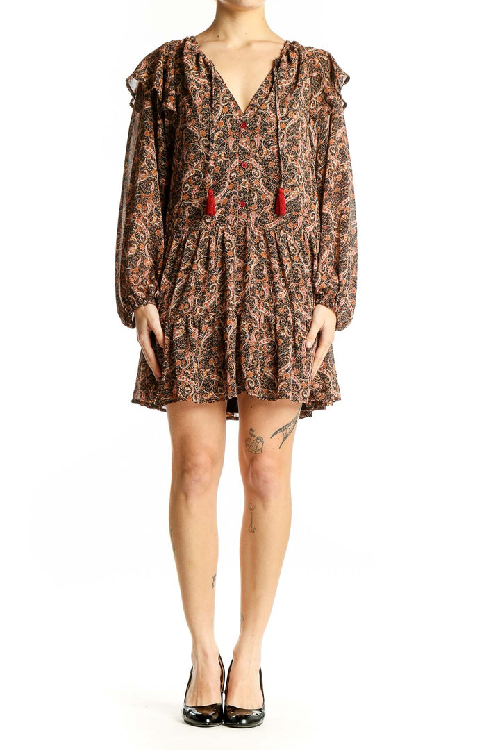 Front view of Aakaa brown paisley boho mini dress with V-neck and red tassels