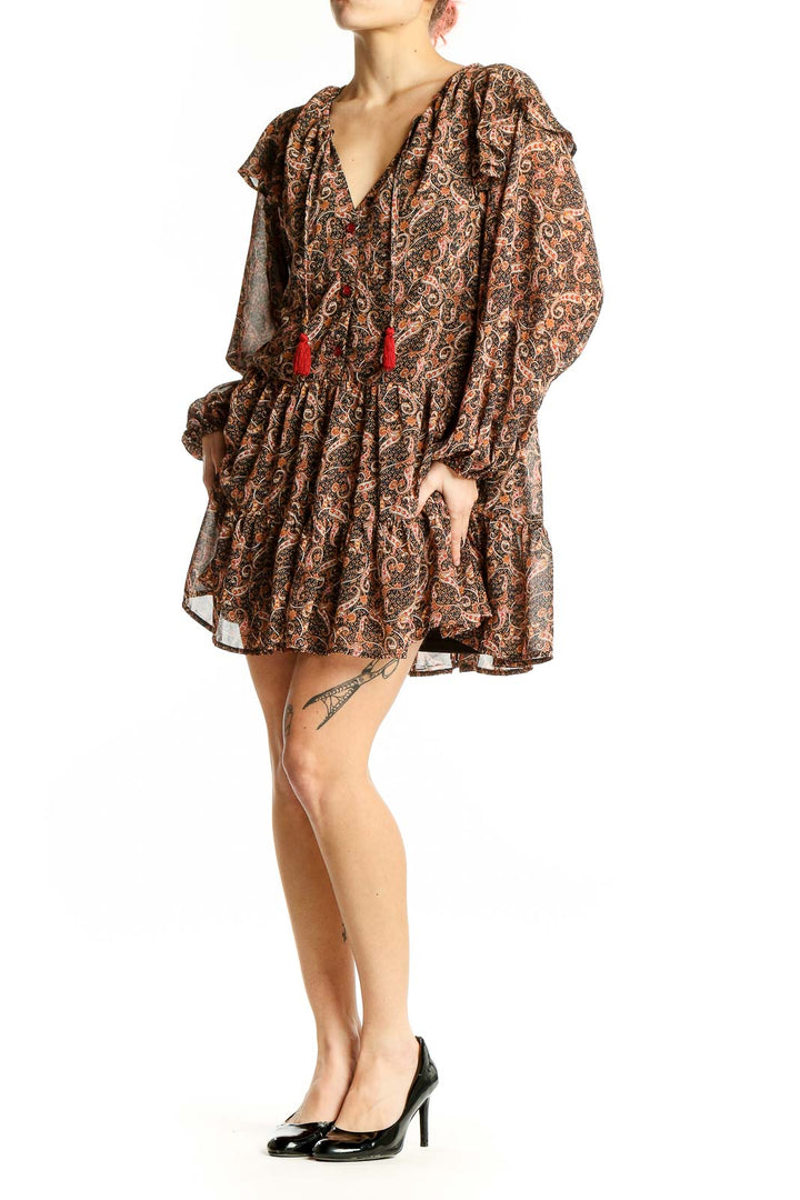 Front view of Aakaa brown paisley boho mini dress with V-neck and red tassels