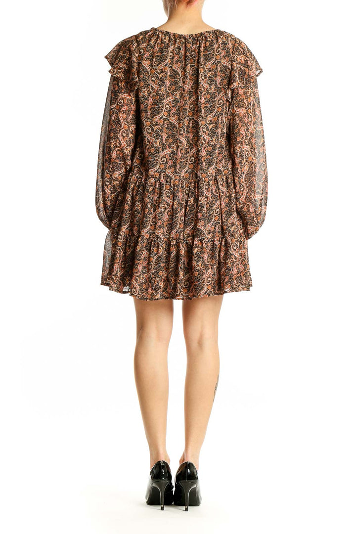Side view of Aakaa brown paisley boho mini dress showing tiered skirt and billowy sleeves
