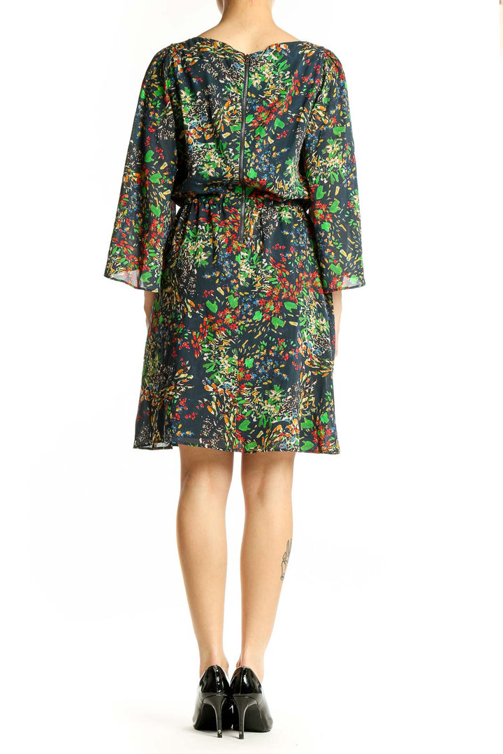 Back view of Alice + Olivia multicolor floral print silk dress showing full length and sleeve detail
