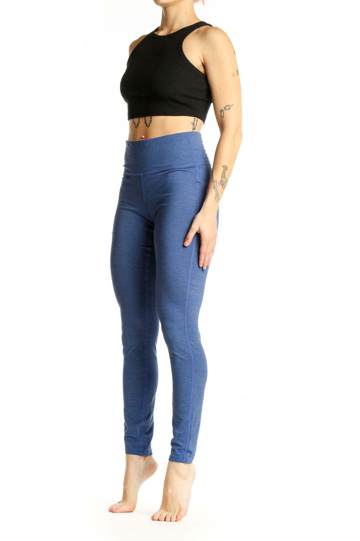 Front view of blue Athleta high-waisted performance leggings