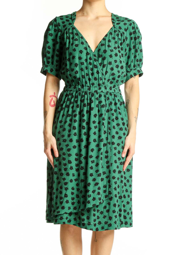 Front view of Maeve green floral print wrap dress with puff sleeves